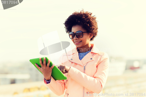 Image of happy young woman or teenage girl with tablet pc