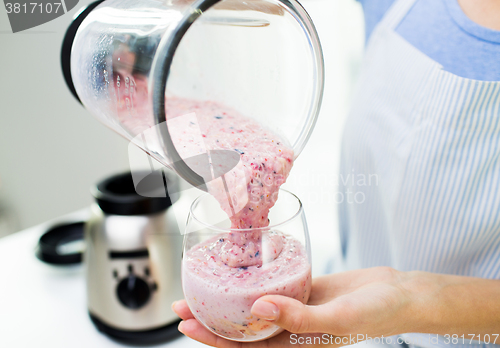 Image of close up of woman with blender and shake at home