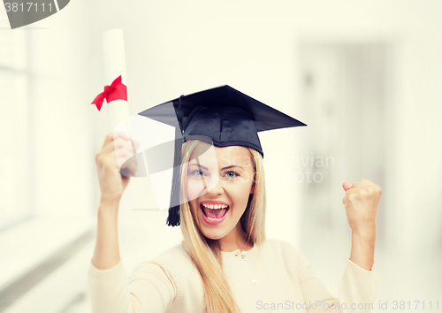 Image of student in graduation cap with certificate