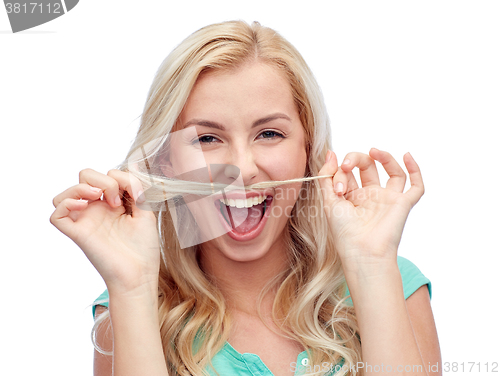 Image of happy young woman making mustache with her hair