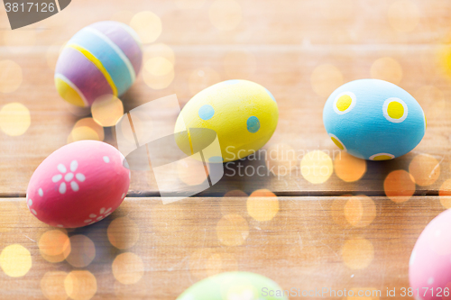 Image of close up of colored easter eggs on wooden surface