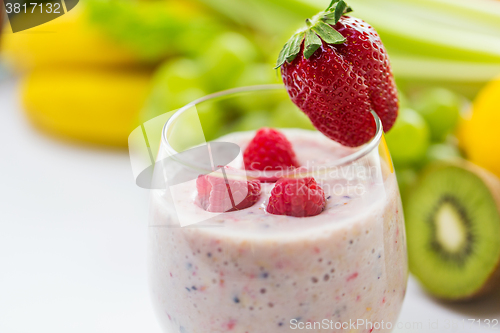 Image of close up of glass with milk shake and fruits