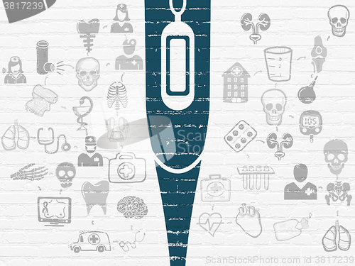Image of Medicine concept: Thermometer on wall background