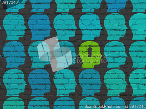 Image of Finance concept: head with keyhole icon on wall background