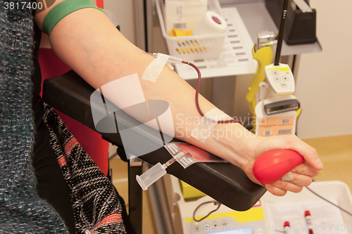 Image of Donor in an armchair donates blood