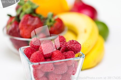 Image of close up of fresh raspberry and fruits on table