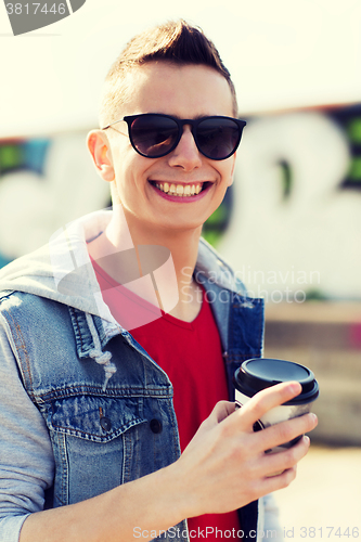 Image of smiling young man or boy drinking coffee