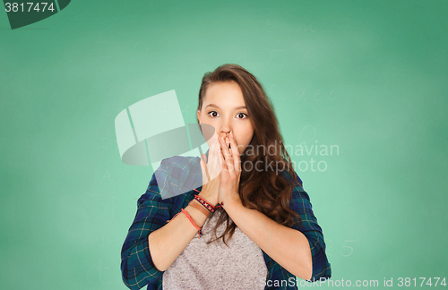 Image of scared teenage student girl over green board