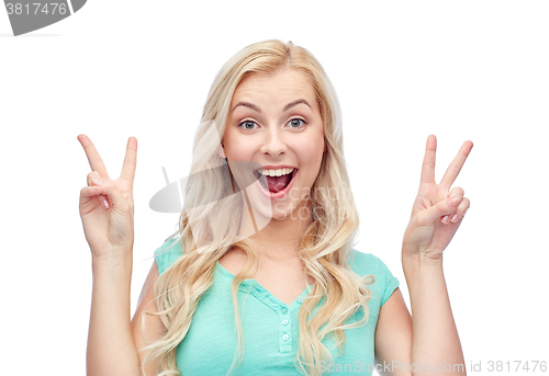 Image of smiling young woman or teenage girl showing peace