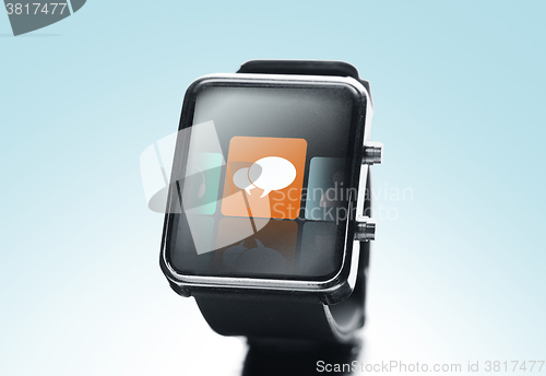 Image of close up of black smart watch with messenger icon