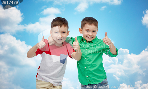 Image of happy smiling little boys showing thumbs up