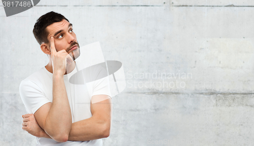 Image of man thinking over gray background