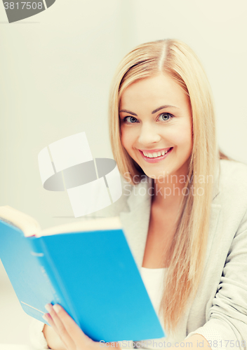 Image of young woman reading book