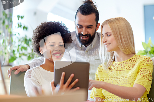 Image of happy creative team with tablet pc in office