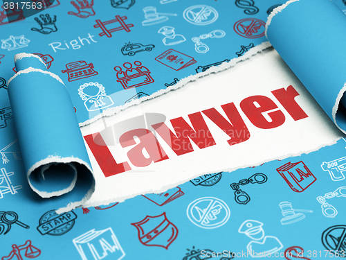 Image of Law concept: red text Lawyer under the piece of  torn paper