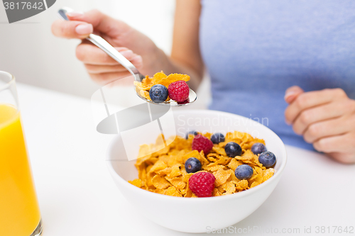 Image of close up of woman eating corn flakes for breakfast