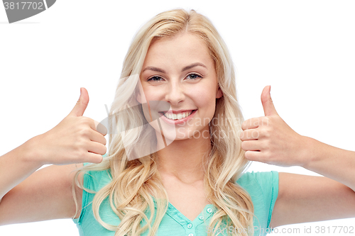 Image of happy woman or teenage girl showing thumbs up