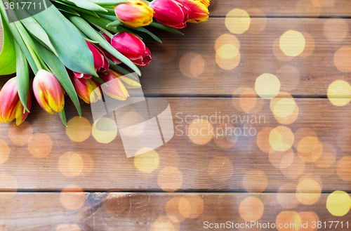 Image of close up of tulip flowers on wooden table