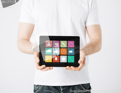 Image of close up of man with app icons on tablet pc