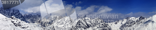 Image of Large panoramic view on snowy mountains in haze at sunny day