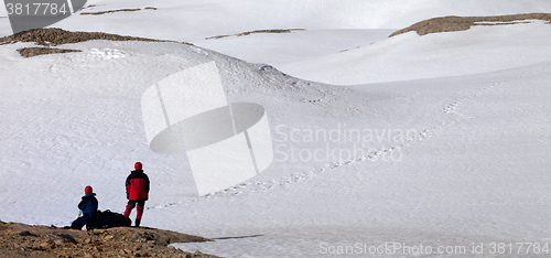 Image of Two hikers on halt in snowy mountain