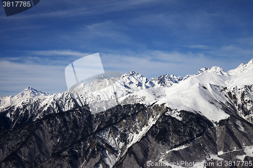 Image of View on snowy mountains in sun day