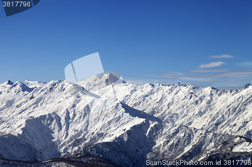 Image of View on snowy mountains in sunny day