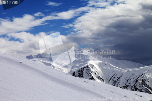 Image of Ski slope in evening and storm clouds