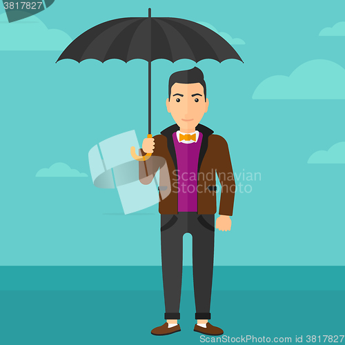 Image of Businessman standing with umbrella.