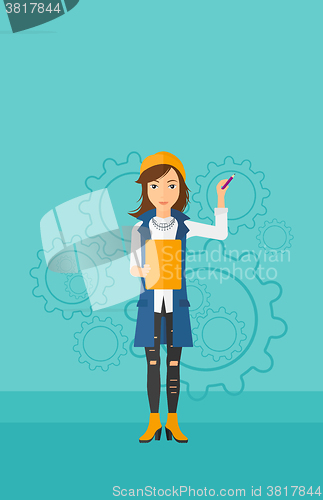 Image of Woman standing on gears background.