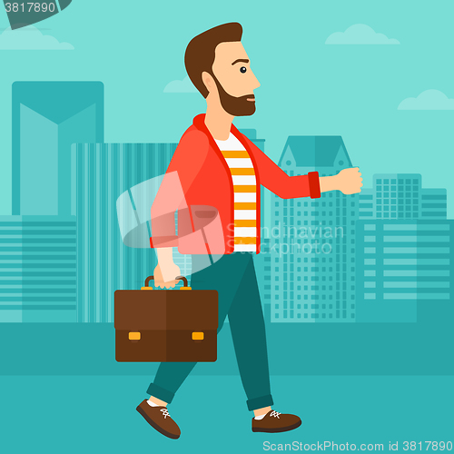 Image of Businessman walking with briefcase. 