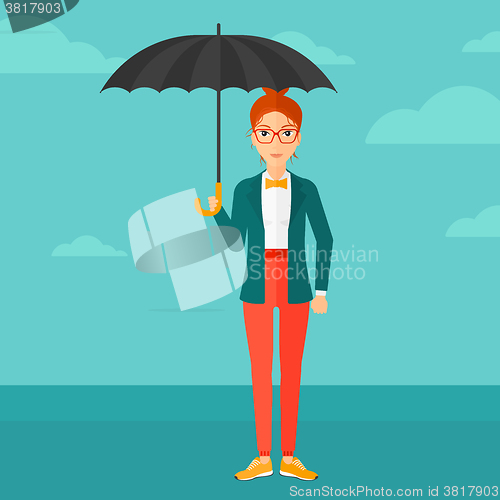 Image of Business woman standing with umbrella.