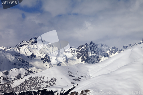 Image of Snowy off-piste slope and mountains in clouds