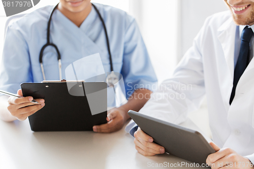 Image of doctors with tablet pc and clipboard at hospital