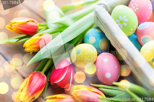 Image of close up of colored easter eggs and flowers