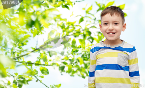 Image of smiling little boy over green natural background