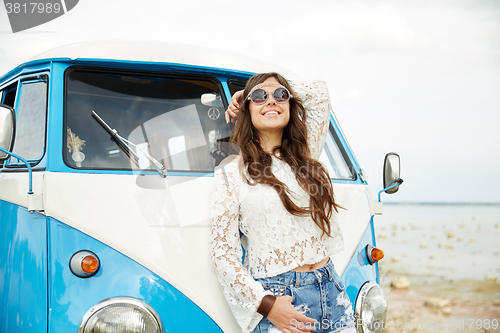 Image of smiling young hippie woman in minivan car