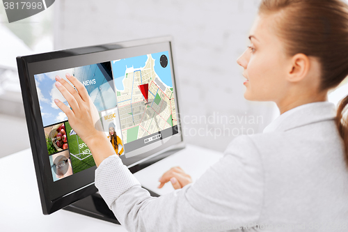 Image of businesswoman with computer touchscreen in office