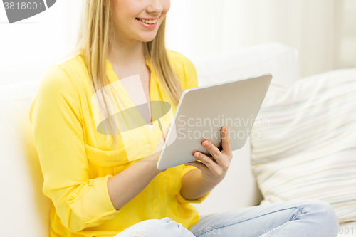 Image of close up of young woman with tablet pc at home