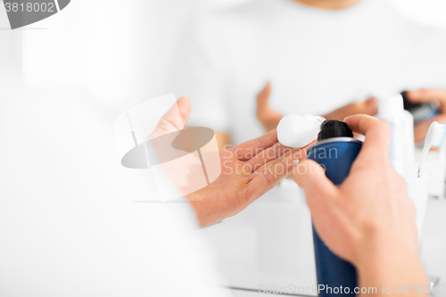 Image of close up of man with shaving foam spray