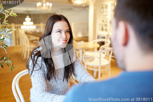Image of happy couple talking at cafe or restaurant