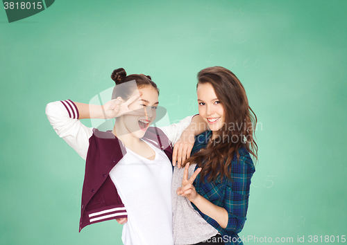 Image of happy teenage student girls showing peace sign