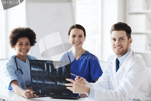 Image of group of happy doctors discussing x-ray image