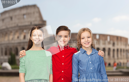 Image of happy boy and girls hugging over coliseum in rome