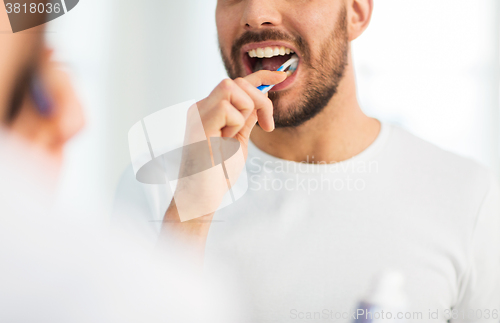 Image of close up of man with toothbrush cleaning teeth