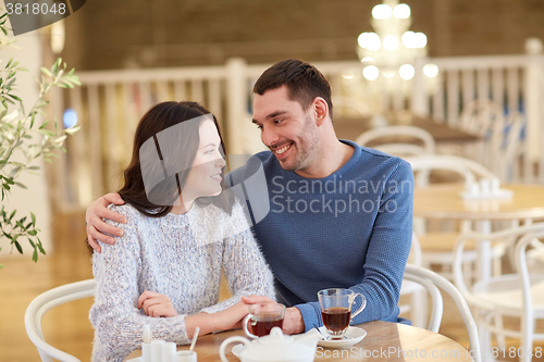Image of happy couple drinking tea at restaurant