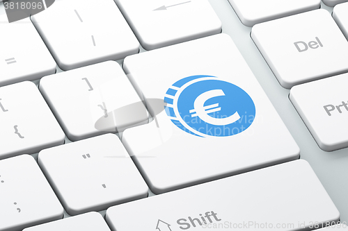 Image of Money concept: Euro Coin on computer keyboard background