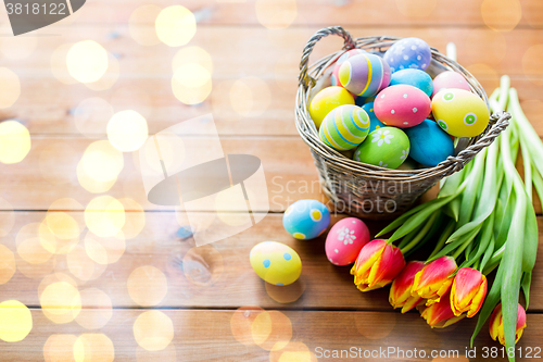 Image of close up of easter eggs in basket and flowers