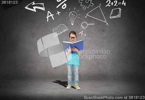 Image of little girl in eyeglasses reading math textbook