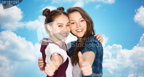 Image of happy smiling teenage girls showing thumbs up